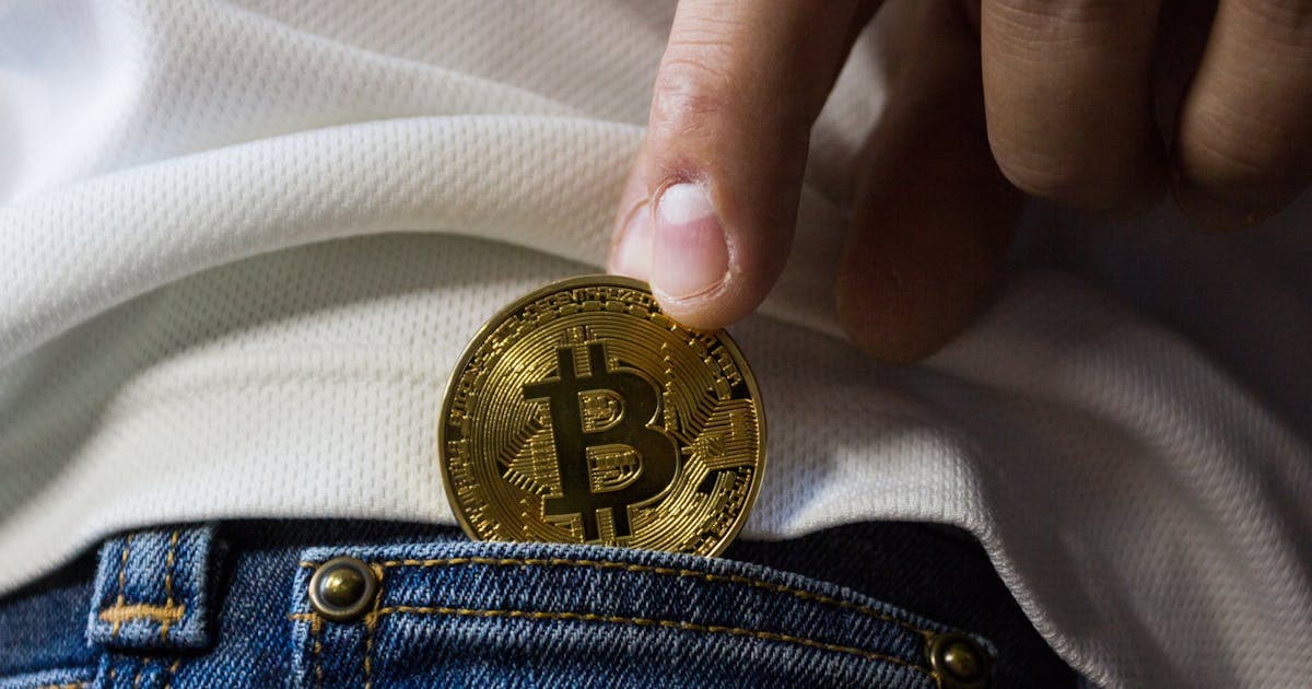 A gold Bitcoin coin, representing the growing role of digital currencies in cross-border payments